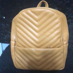 Mustard colored backpack purse